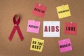 Red ribbon aids ribbon on notice board with words of encouragement for Aids/hiv patient