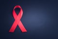 Red ribbon awareness on black background Royalty Free Stock Photo