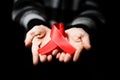 Red ribbon awareness on woman human hand aged white background: Royalty Free Stock Photo