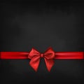 Red ribbon with bow on black background Royalty Free Stock Photo