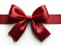 Red ribbon bow with depth, satin or silky texture, subtle gradient, overhead light source, soft shadows, contours and creases Royalty Free Stock Photo