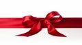 Red ribbon bow on left of long ribbon for banner isolated on white background with copy space Royalty Free Stock Photo