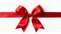 Red ribbon bow with long, straight ribbon for banner, isolated on white background with copy space Royalty Free Stock Photo
