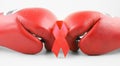 Red ribbon with boxing gloves, wrestling symbol. Royalty Free Stock Photo