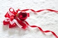 Red Ribbon And Christmas Ball On Snow Background