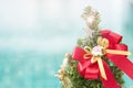 Red ribbon on christmas tree with shiny star over blurred blue background Royalty Free Stock Photo