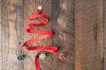 Red ribbon Christmas tree shape on a wooden background Royalty Free Stock Photo