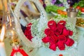 Red ribbon . Red engagement flowers on white table . Bride and groom with Engagement gold rings put on the red wedding bouquet . Royalty Free Stock Photo