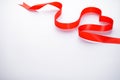 Red ribbon in the form of a heart on a white background, with place for text. Valentine`s Day. Love concept Royalty Free Stock Photo
