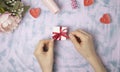 Red ribbon on a gift box on a light background. Christmas and New Year or season greetings. Selective focus Royalty Free Stock Photo