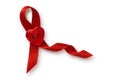 Red ribbon with heart shaped button on white background - Aids awareness concept Royalty Free Stock Photo