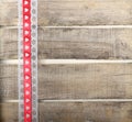 Red ribbon of hearts on old wooden background