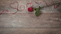 The red ribbon is lined in the shape heart on a dark wooden table. Valentines day background, rustic style. Valentines day table p Royalty Free Stock Photo