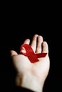 Red ribbon in a man hand Royalty Free Stock Photo