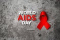 Red ribbon with text world aids day awareness campaign