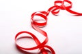 Red ribbon on wooden background