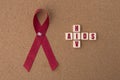 Red ribbons aids ribbon with AIDS/HIV word on notice board. Royalty Free Stock Photo