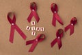 Red ribbons aids ribbon with AIDS/HIV word on notice board. Royalty Free Stock Photo