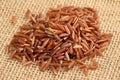 Red rice on jute background Royalty Free Stock Photo