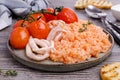 Red rice with seafood tentacles and tomatoes