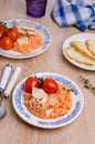 Red rice with seafood tentacles and tomatoes