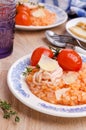 Red rice with seafood tentacles and tomatoes