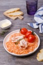 Red rice with seafood tentacles and tomatoes