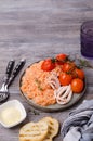 Red rice with seafood tentacles and tomatoes