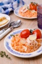 Red rice with seafood tentacles and tomatoes