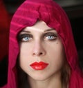 Red riding hood with smokey blue eyes and scarlet lips