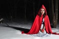 Red Riding Hood in the winter night forest Royalty Free Stock Photo