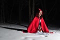 Red Riding Hood in the winter night forest Royalty Free Stock Photo