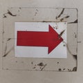 a red right-pointing arrow on a white background within a grungy frame Royalty Free Stock Photo