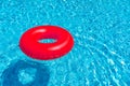 Red ring floating in blue swimming pool. Inflatable ring, rest concept Royalty Free Stock Photo