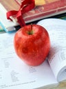 Red ripe apple with English textbooks Royalty Free Stock Photo