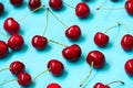 Red ripe cherry berries on blue background. Cherry pattern. Flat lay. Healthy food concept Royalty Free Stock Photo