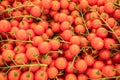 Red ripe cherry tomatoes closeup on the farm market stall. Food background