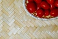 Red ripe cherry tomatoes mini basket on a light wooden background copy space Royalty Free Stock Photo