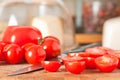 Red ripe cut cherry tomatoes on cutting board