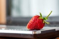 Red ripe delicious strawberries near laptop, delicious food while working in the office_