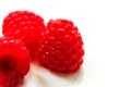 Red ripe fresh raspberries on white surface close-up Royalty Free Stock Photo