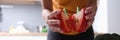 Red ripe pepper cut in half in female hands in kitchen Royalty Free Stock Photo