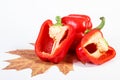 Red ripe peppers with autumnal leaf on white background, healthy nutrition and autumn concept Royalty Free Stock Photo