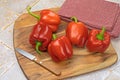 Red ripe peppers on wooden background Royalty Free Stock Photo
