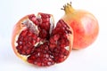 Red ripe pomegranate fruits and open pomegranate on white background.