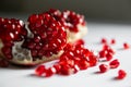 Red ripe pomegranate on the white table close up. Macro image