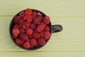 red ripe raspberries in a brown cup Royalty Free Stock Photo