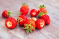 Red ripe strawberries on the table, a small snail on the berry. Delicious healthy summer vitamins