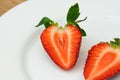 Red ripe strawberry slice on white plate Royalty Free Stock Photo