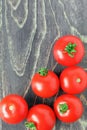 Red ripe tomatoes on a brown wooden background. Top view. Copy space